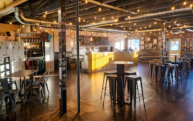 Fairbanks brewery interior with bar, seating, and merchandise display for Arctic Ale Trail tour.
