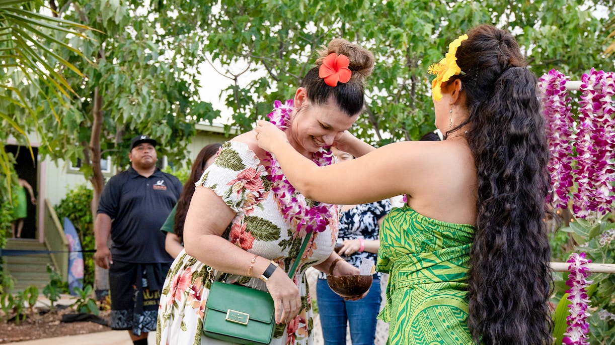 Guests receiving Lei garlands at Mauka Warriors Luau.