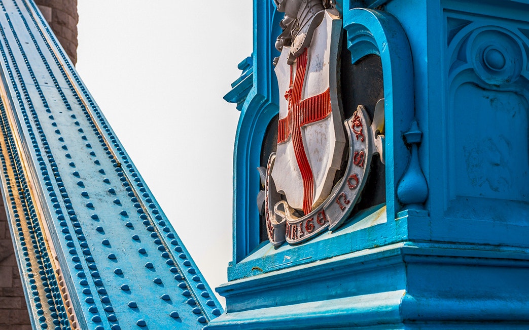 Tower Bridge close-up of blue structure and emblem, London.