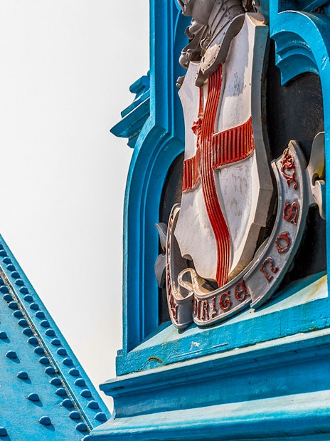Tower Bridge close-up of blue structure and emblem, London.