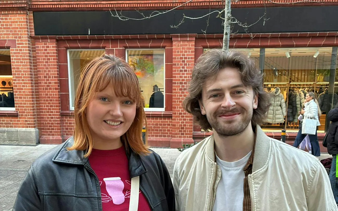Dublin street scene with two people smiling, part of the Murder Mystery city exploration game.