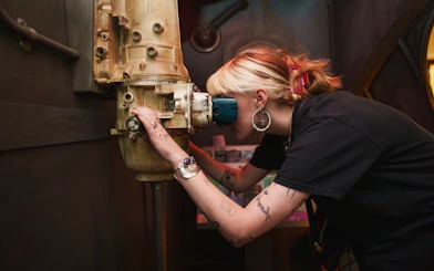 Person looking through a periscope at the National Wax Museum exhibit.
