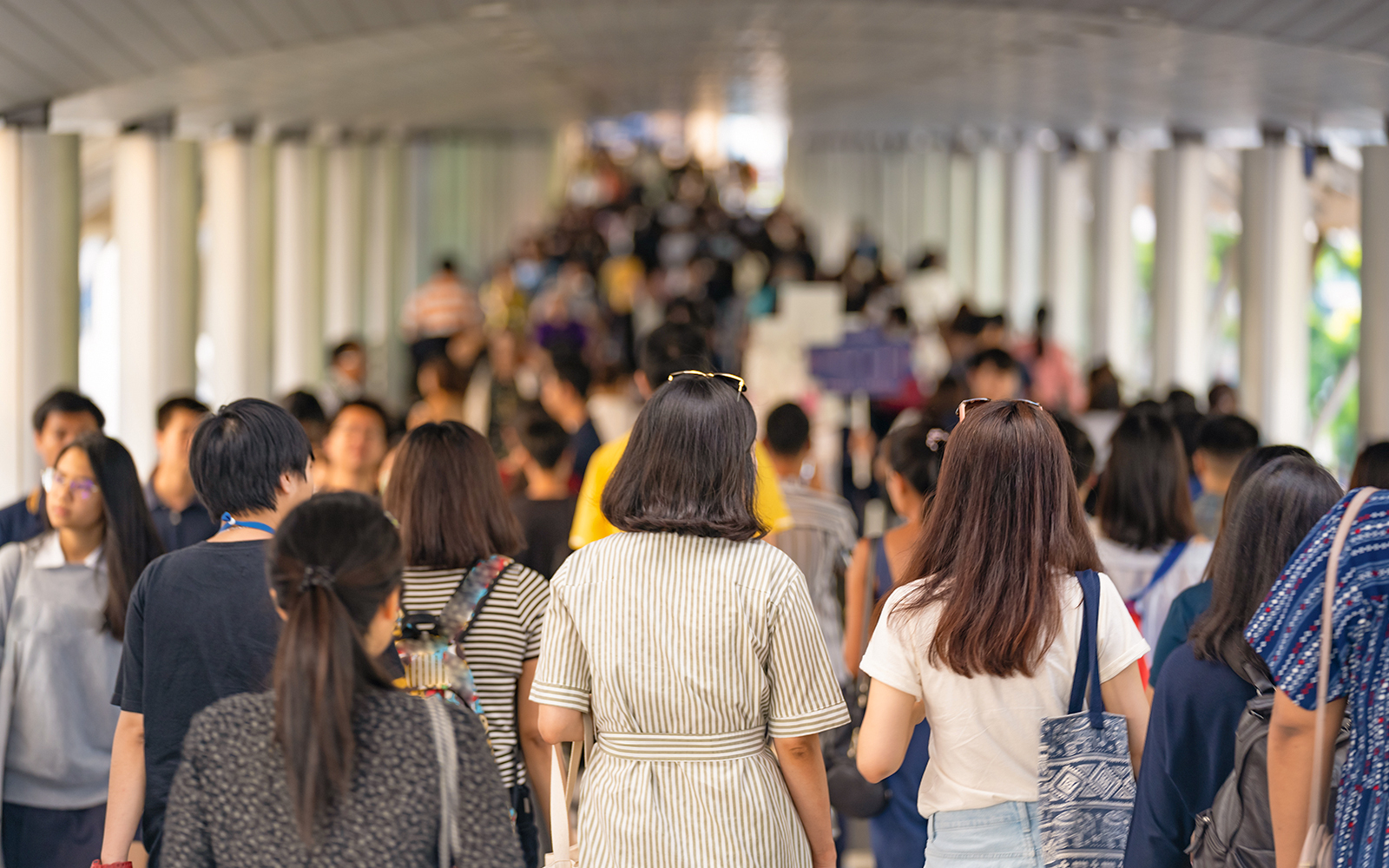 Crowd walking through Times Square, New York City, surrounded by a dull underground environment.