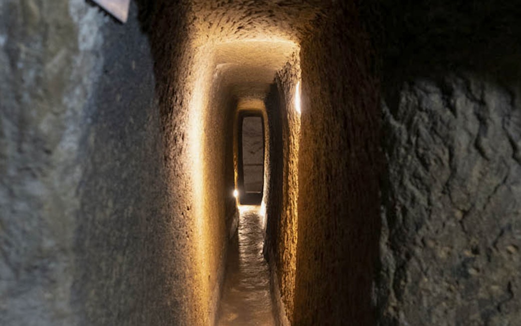 Naples Underground tunnel with illuminated stone walls.