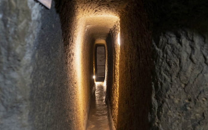 Naples Underground tunnel with illuminated stone walls.