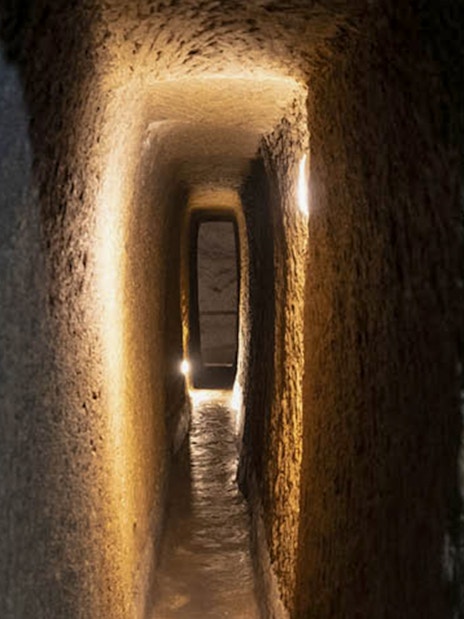 Naples Underground tunnel with illuminated stone walls.