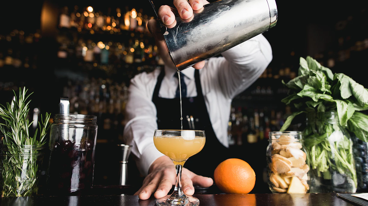 Bartender crafting a cocktail at Edge NYC Restaurant - ANA Bar & Eatery.