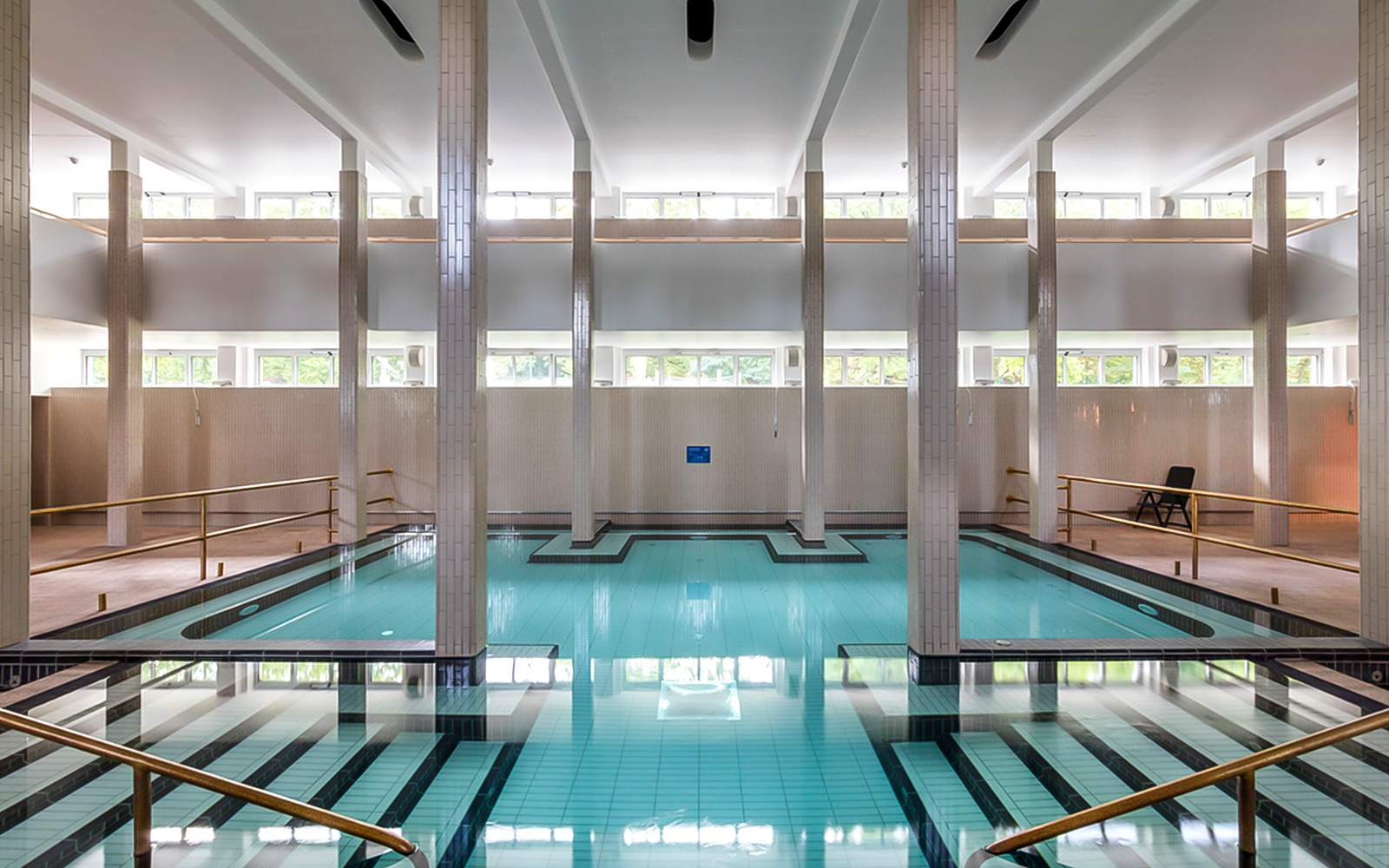 Indoor pool at Palatinus Spa Budapest with tiled columns and natural light.