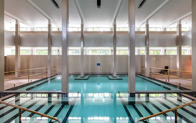 Indoor pool at Palatinus Spa Budapest with tiled columns and natural light.