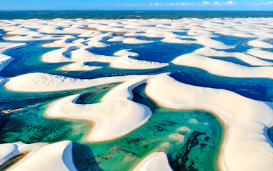 Sand dunes and turquoise lagoons in Barreirinhas, Lagoa Bonita 4x4 Circuit, Brazil.