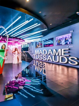 Madame Tussauds Las Vegas entrance with neon lights and wax figure display.