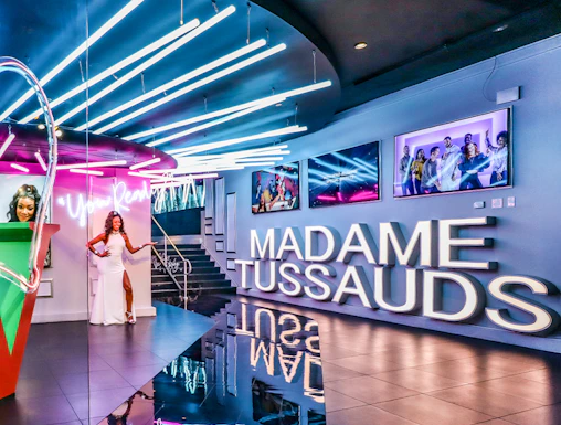 Madame Tussauds Las Vegas entrance with neon lights and wax figure display.