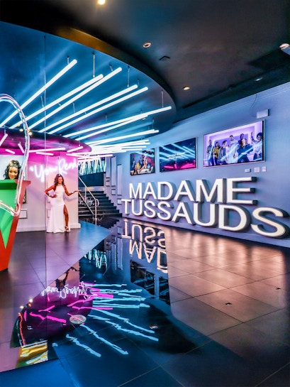 Madame Tussauds Las Vegas entrance with neon lights and wax figure display.
