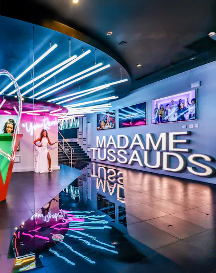 Madame Tussauds Las Vegas entrance with neon lights and wax figure display.
