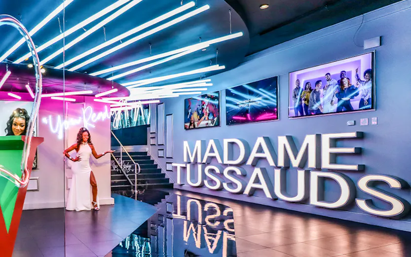 Madame Tussauds Las Vegas entrance with neon lights and wax figure display.