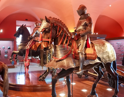 Royal Armoury exhibit with armored knights on horseback, Royal Palace of Madrid.