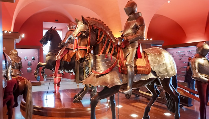 Royal Armoury exhibit with armored knights on horseback, Royal Palace of Madrid.