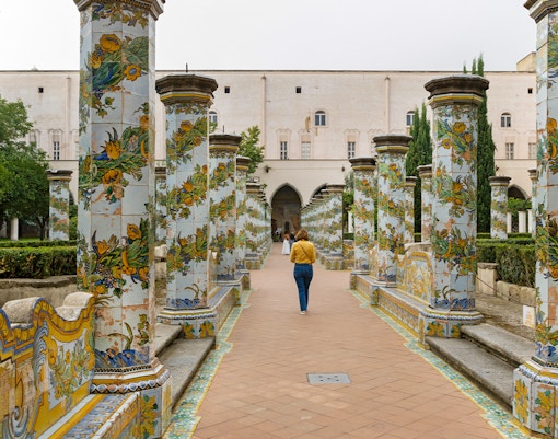 Cloister with painted columns at Santa Chiara Monastery, Naples, Italy.