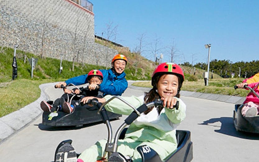 Children enjoying a luge ride at Skyline Luge Busan, South Korea.