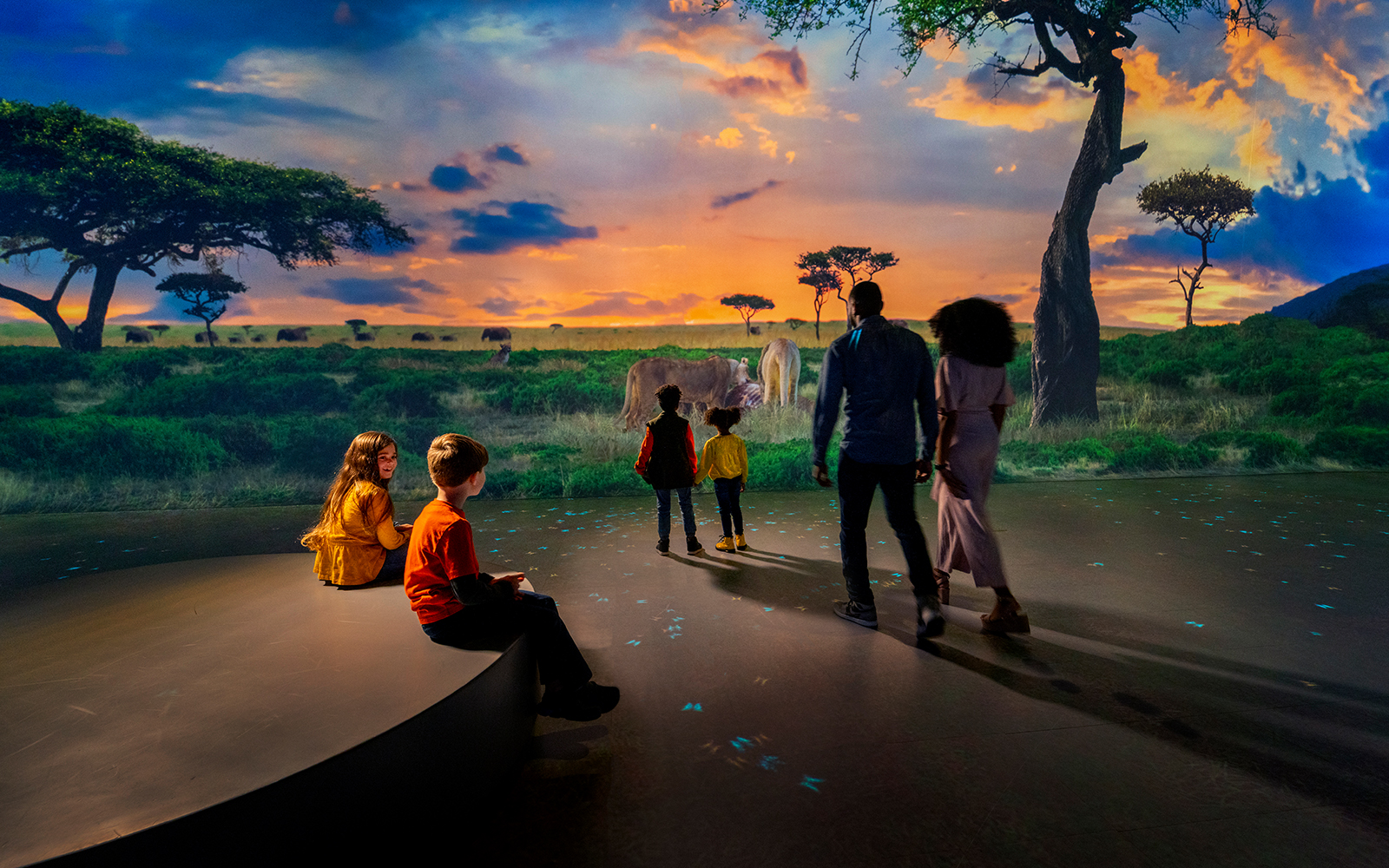 Family viewing immersive savanna exhibit at Las Vegas attraction.