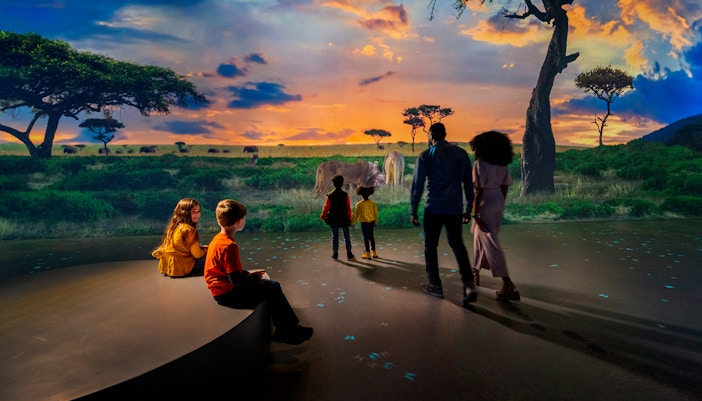 Family viewing immersive savanna exhibit at Las Vegas attraction.