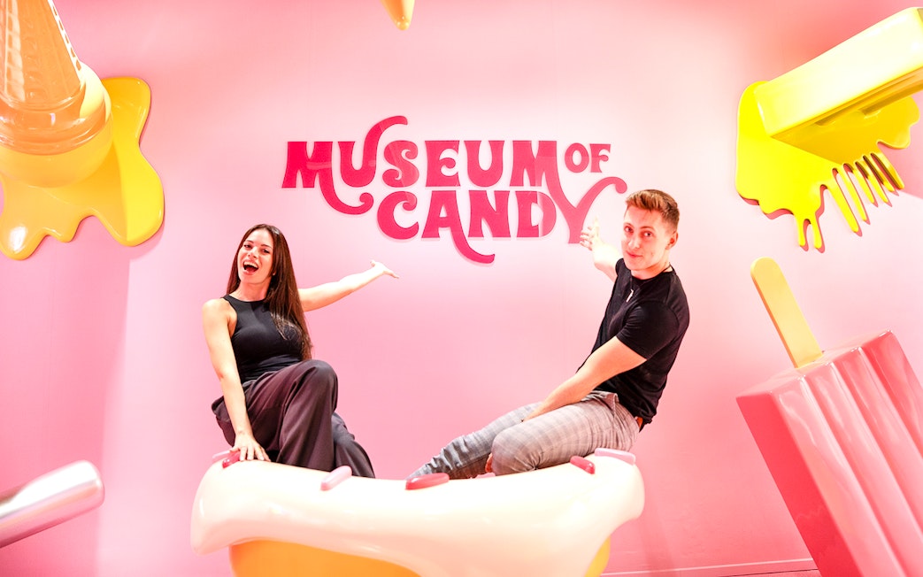 Visitors on cupcake prop at Museum of Candy, Dubai.