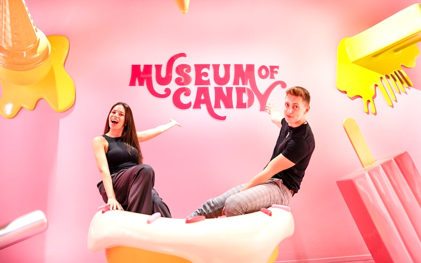 Visitors on cupcake prop at Museum of Candy, Dubai.