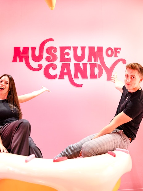 Visitors on cupcake prop at Museum of Candy, Dubai.