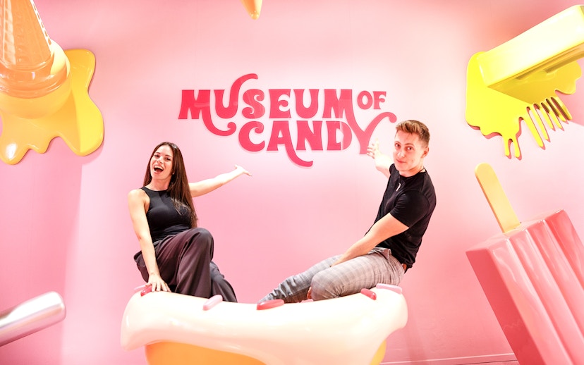Visitors on cupcake prop at Museum of Candy, Dubai.
