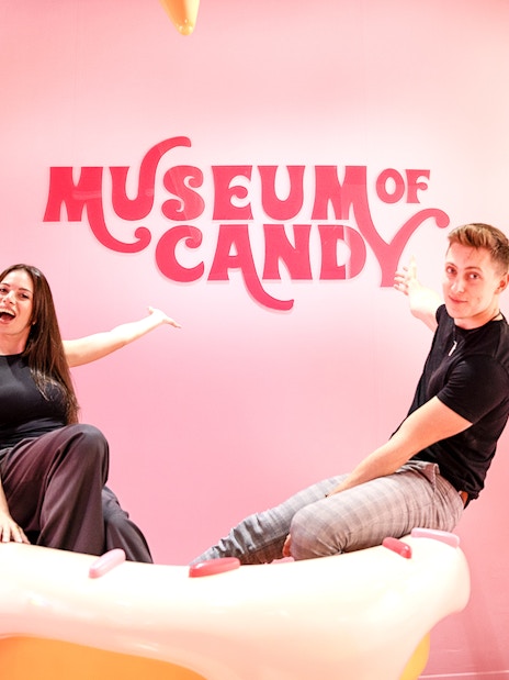 Visitors on cupcake prop at Museum of Candy, Dubai.