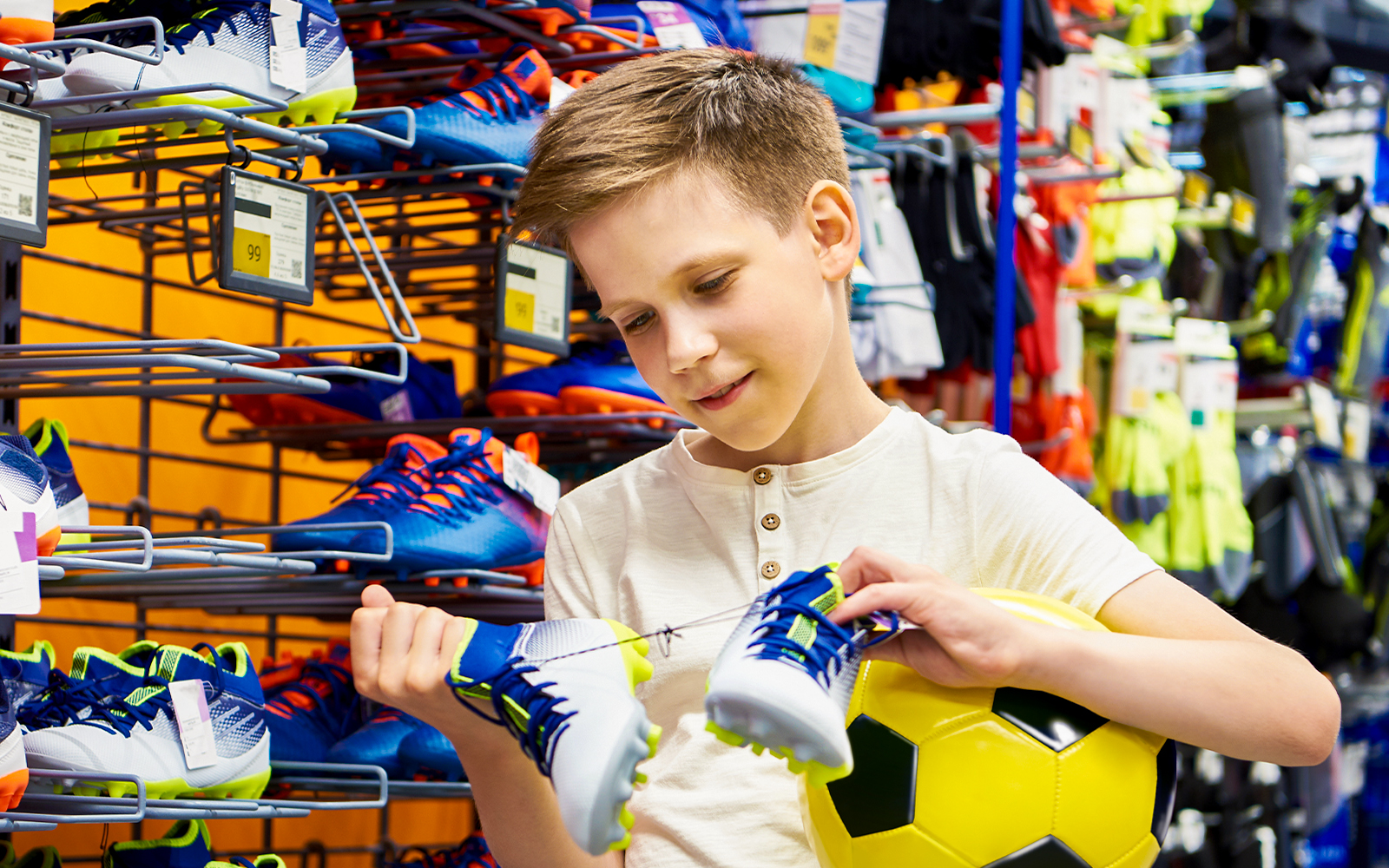 Child purchasing mini football kit at FC Porto store in Porto, Portugal.