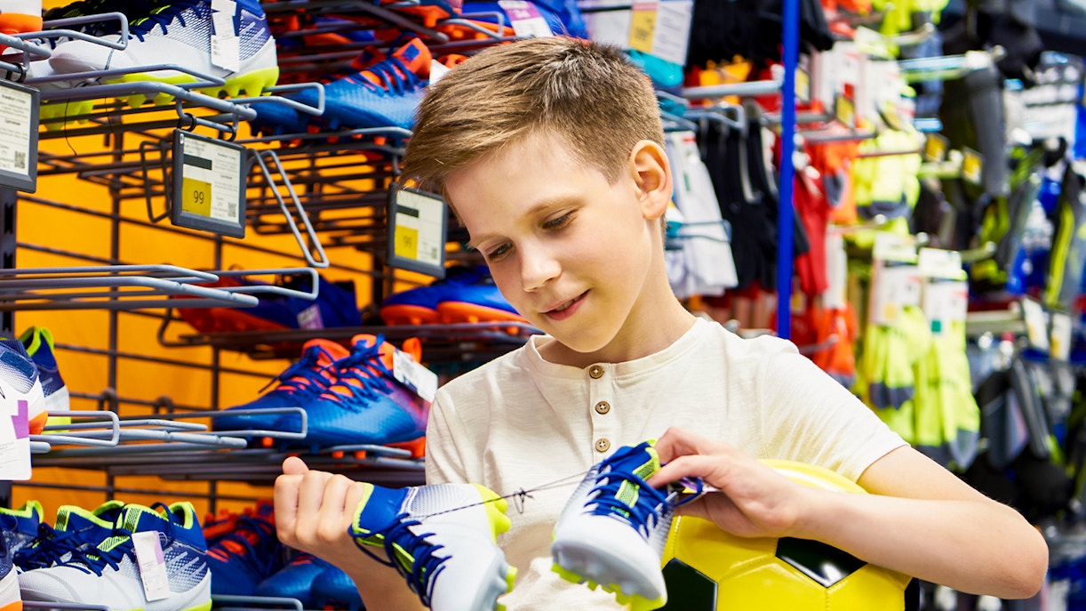 Kid buying mini football kit from FC Porto store