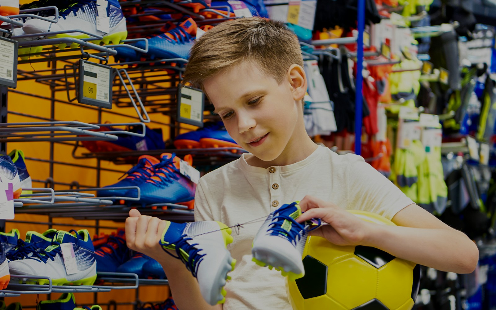 Child purchasing mini football kit at FC Porto store in Porto, Portugal.