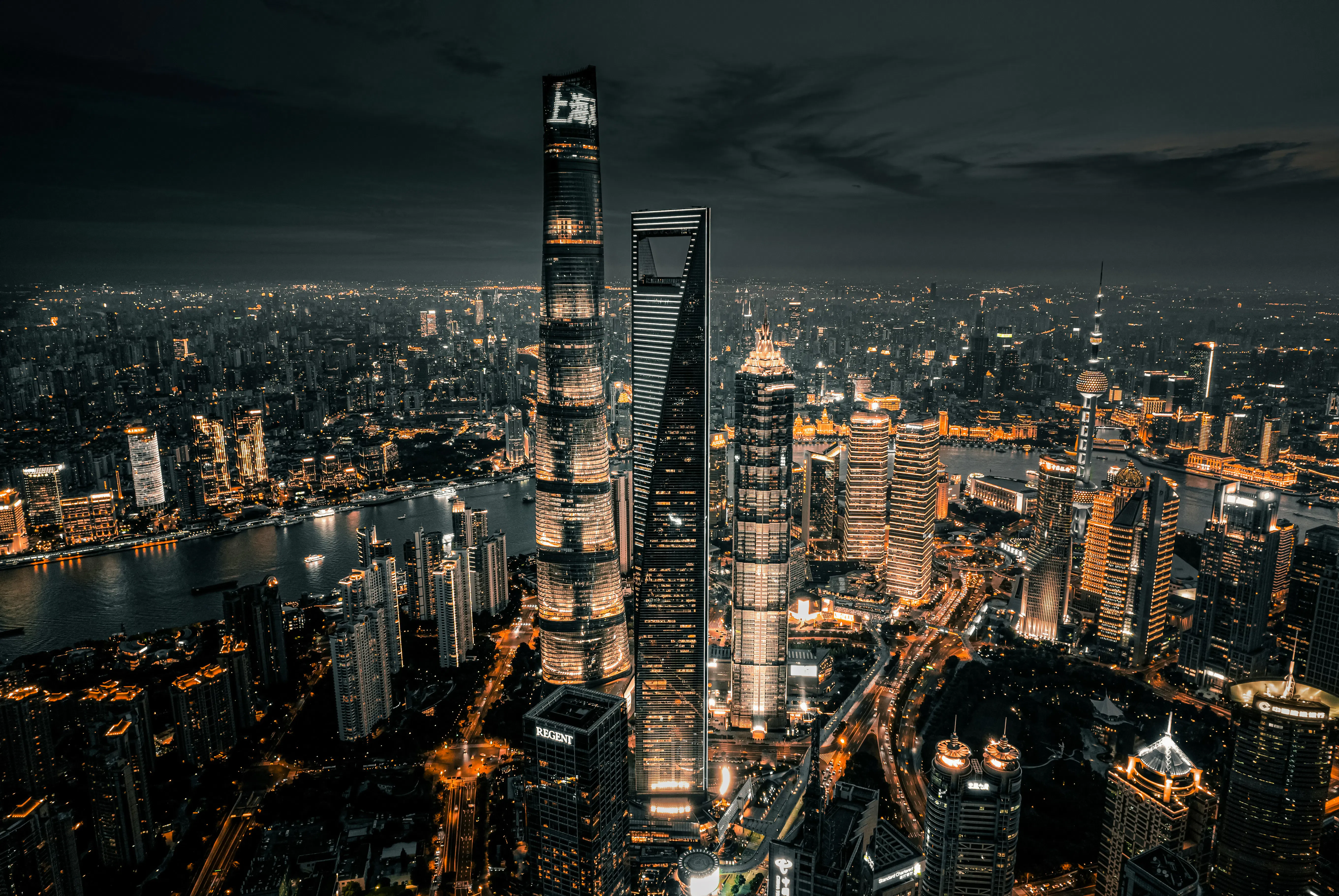 Shanghai skyline with Oriental Pearl Tower illuminated at night.