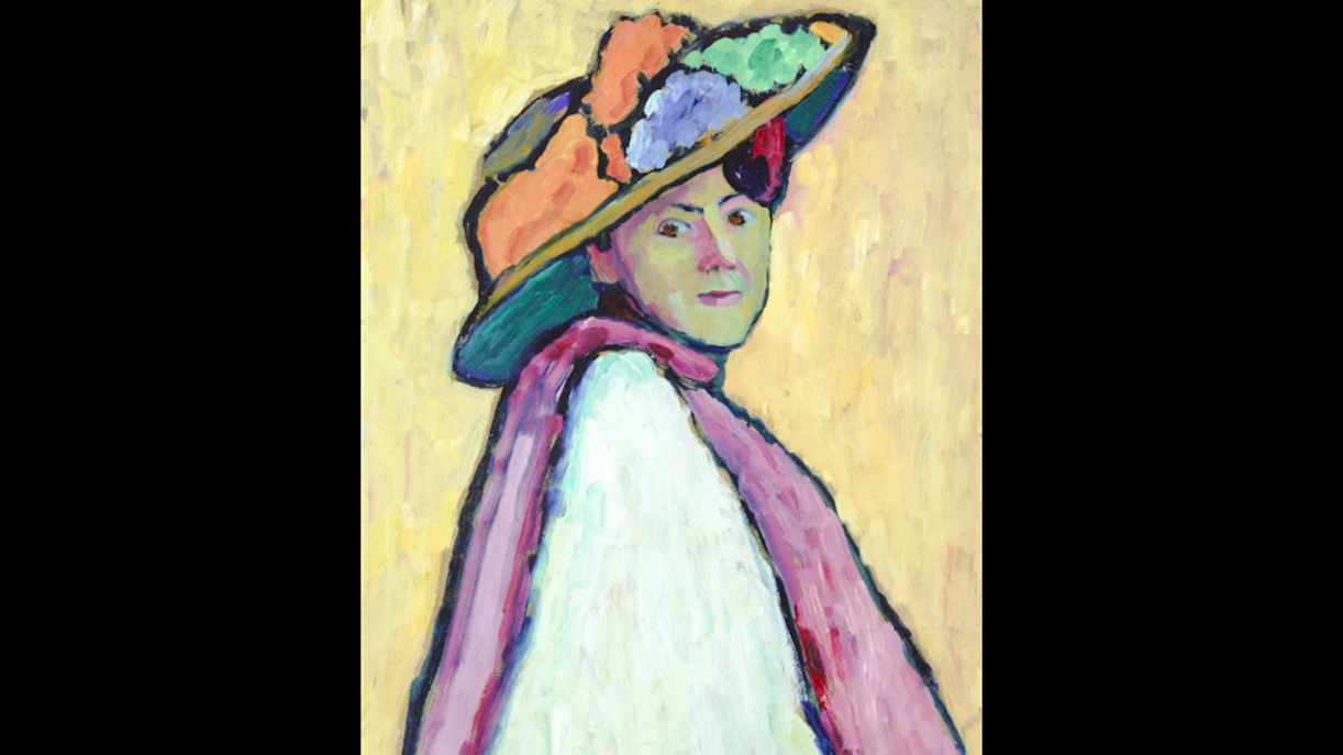 Portrait of a person in a colorful hat and scarf at Museum of Modern Art Paris, France.