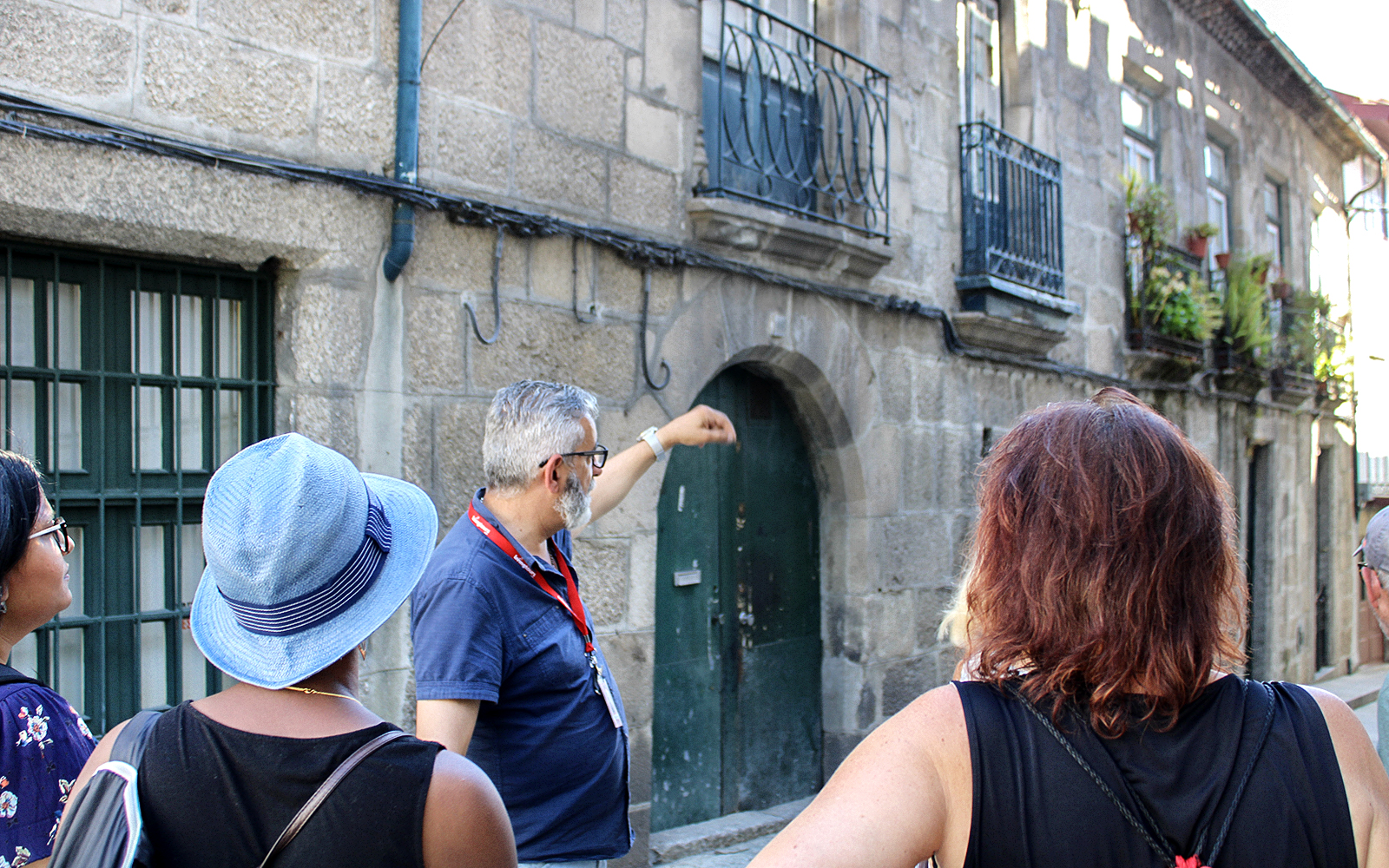 Tour guide explaining historical building in Braga during full-day tour from Porto.