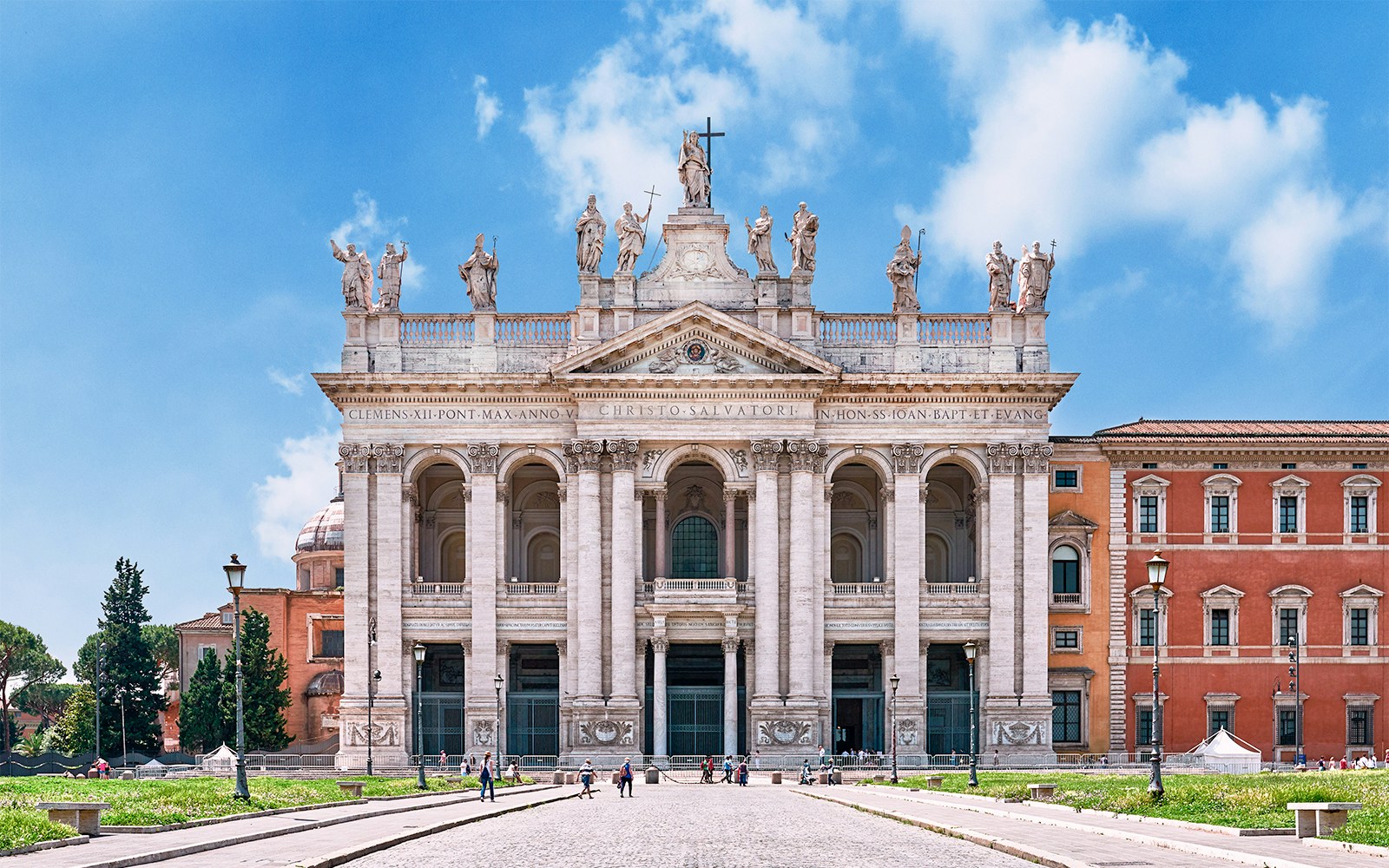 Basilica of San Giovanni in Laterano facade in Rome, Italy, with statues and columns.