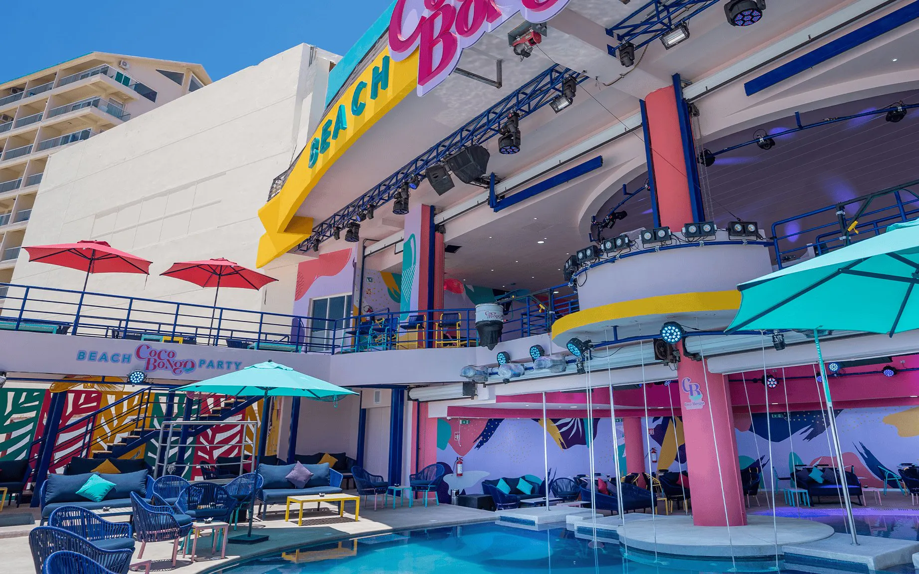 Coco Bongo Beach Party venue with colorful decor and poolside seating.