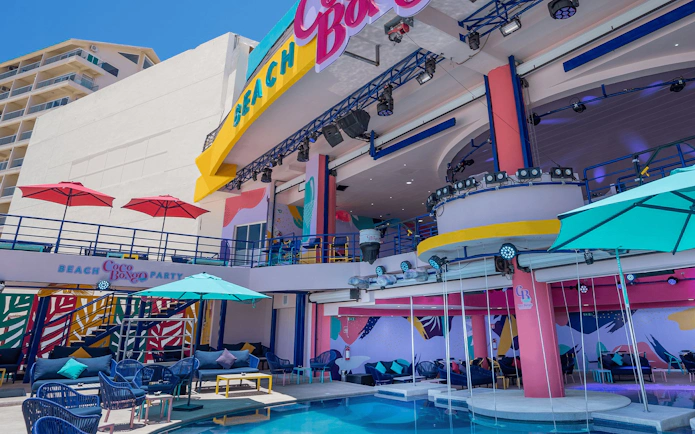 Coco Bongo Beach Party venue with colorful decor and poolside seating.