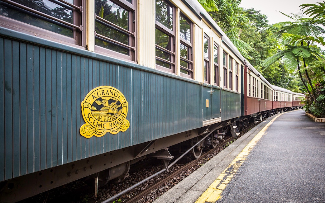 Kuranda Scenic Railway train on a lush forest track in Queensland, Australia.