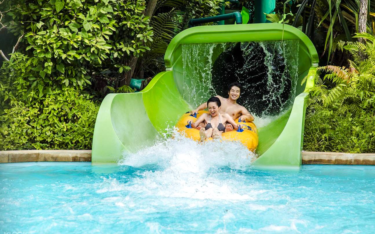 Visitors enjoying a water slide at Adventure Cove Waterpark, Singapore.