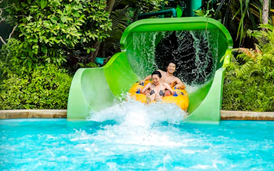 Visitors enjoying a water slide at Adventure Cove Waterpark, Singapore.