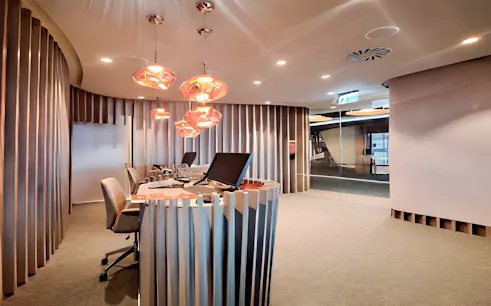 ANA Lounge reception area at Lisbon Airport with modern decor and seating.