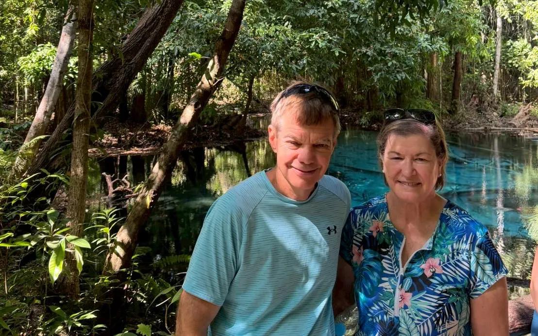 Couple standing by the Emerald Pool in Krabi jungle, part of a small-group tour.