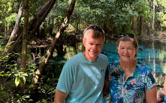 Couple standing by the Emerald Pool in Krabi jungle, part of a small-group tour.