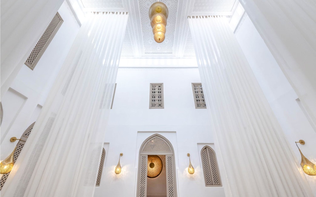 Luxury steam hammam interior with ornate ceiling and elegant lighting fixtures.