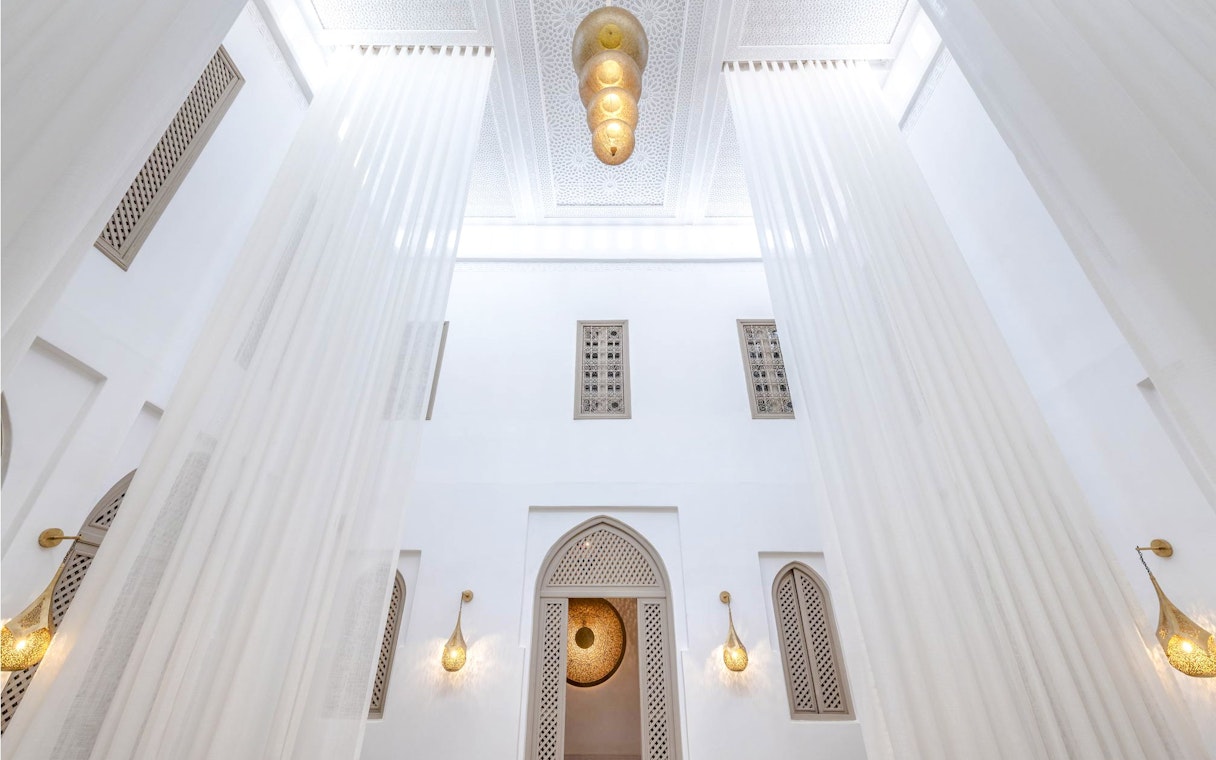 Luxury steam hammam interior with ornate ceiling and elegant lighting fixtures.