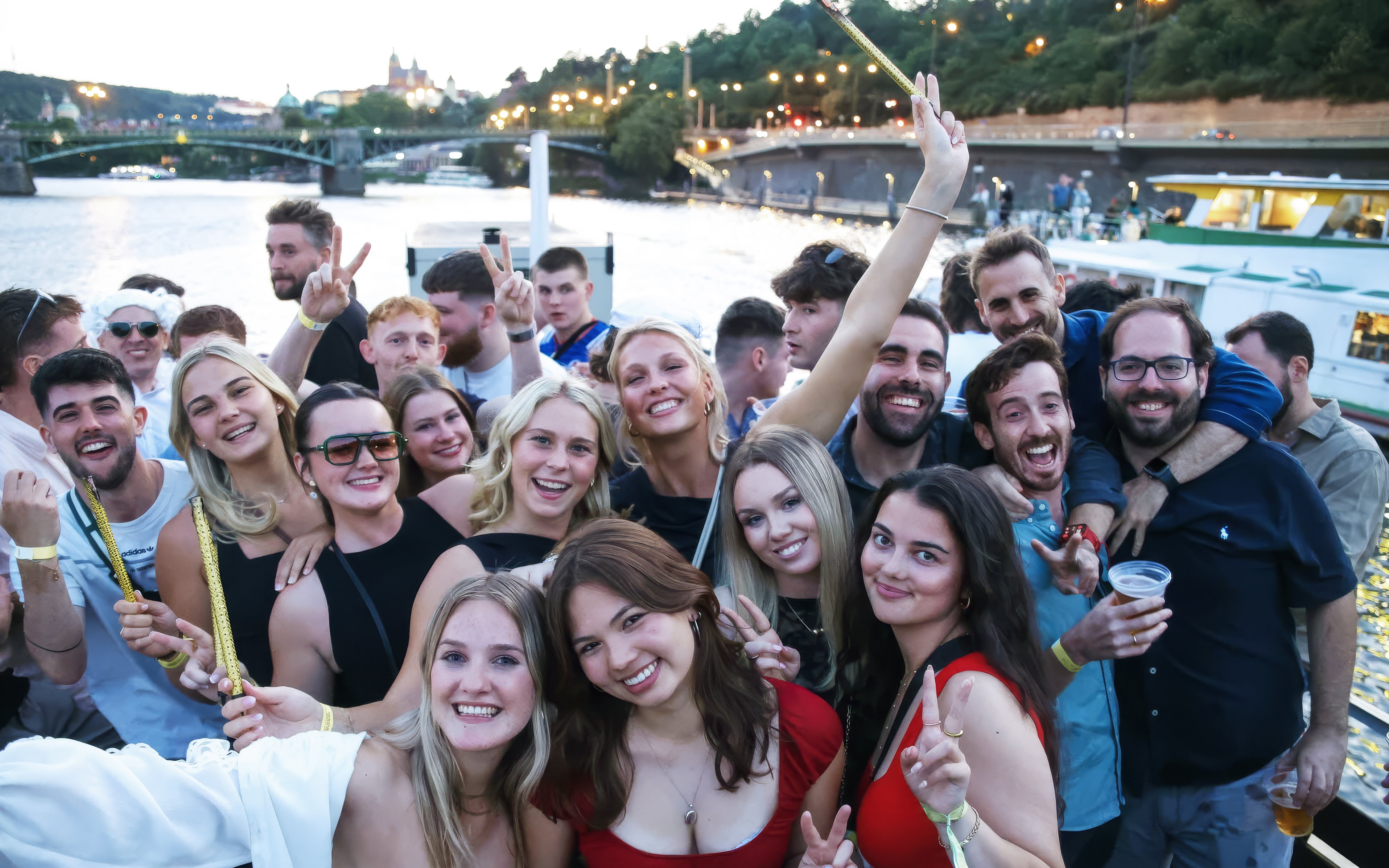 Group enjoying a boat cruise party on the Vltava River in Prague.