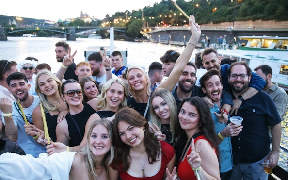 Group enjoying a boat cruise party on the Vltava River in Prague.
