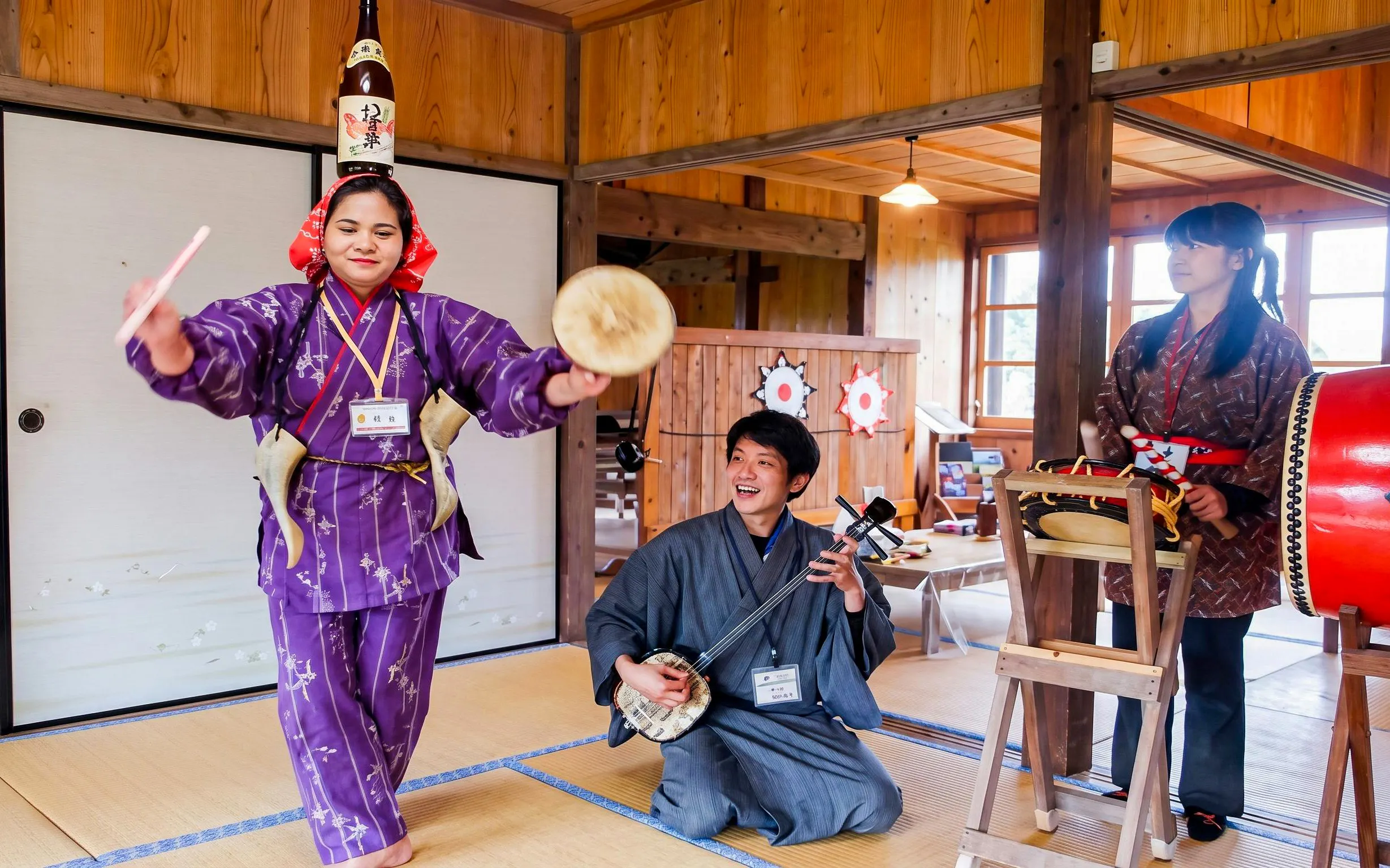 Traditional performance at Ishigaki Yaima Village with musicians and dancer.
